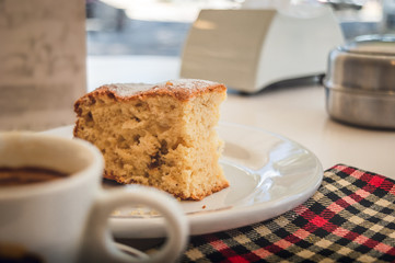 Closeup of a slice of cake and a cup of coffee