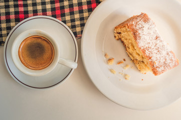 Flat lay of a slice of cake and a cup of coffee