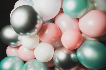 A lot of different colorful balloons on black background. Beautiful celebration.