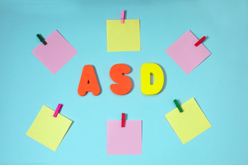 ASD. Autism spectrum disorder. Autism Concept with color paper stickers on blue background. Top view. Flat lay.