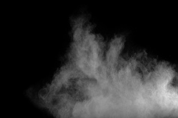 Fototapeta na wymiar White powder explosion.Freeze motion of white dust particles on black background.