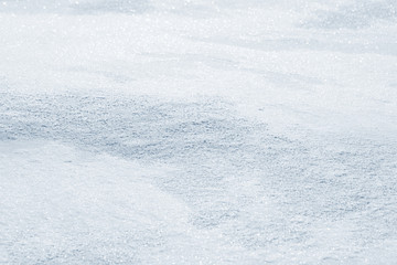 Fresh snow background texture. Winter background with snowflakes and snow mounds. Snow lumps.