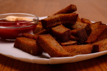 crackers from bread and salt and laurel on wooden background