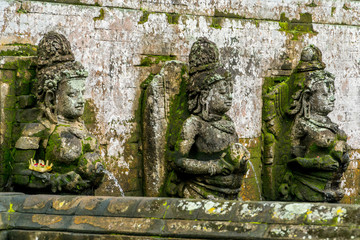 Fototapeta na wymiar Bathing Temple traditional figures in Goa Gajah Temple (Elephant Cave) on Bali