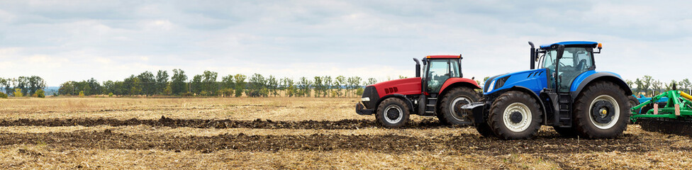 Two tractors with plows working in the field - obrazy, fototapety, plakaty