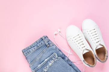White sneakers on pastel pink background. Flat lay, top view minimal background