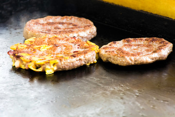 Cooking and Fraying Burgers and Hamburgers on Grill
