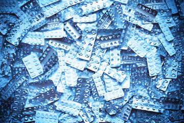 Many empty blister packages on white background, drug overdose, misuse or addiction concept