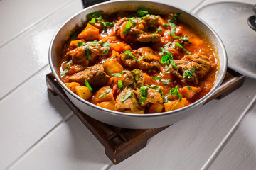 Stuffed meat with potatoes in a tomato sauce on a boiler