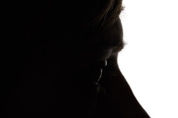 Close up view of woman looking away in darkness on white