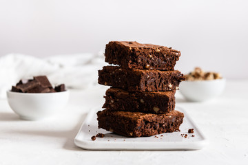 A stack of chocolate brownies on white background, homemade bakery and dessert. Bakery,...