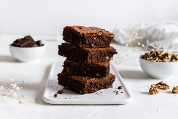 Homemade dark chocolate brownies on white table. Delicious bitter sweet and fudge. Chocolate cake