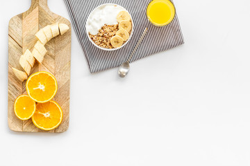 Healthy granola and orange juice for colorful breakfast on white background top view mock-up