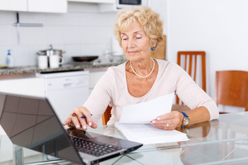 Senior woman filling up documents