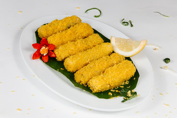 Traditional oriental cuisine of  Vietnam. Tempura chicken in breading with lemon on on pineapple leaf