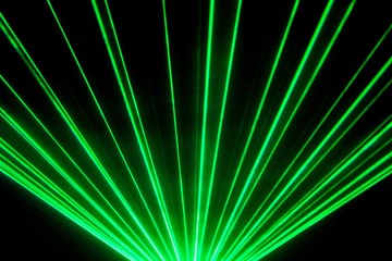 Green laser show nightlife club stage and shining sparkling rays. Luxury entertainment in nightclub event, festival, concert or New Years Eve. Ray beams are symbol for science and universe research - 257688359