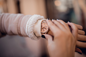 Stylish beige watch on woman hand
