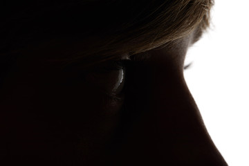 Close up view of woman looking away in darkness on white