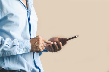 businessman using mobile phone touch screen in office with hands typing smart phone texting messaging lifestyle working app device technology internet social data online concept vintage style.