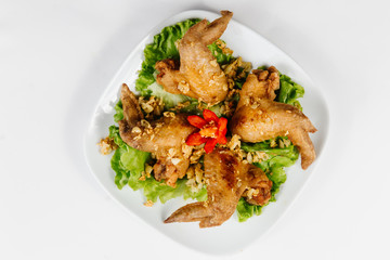 Traditional oriental cuisine of  Vietnam. Breaded Chicken Wings with green salad 