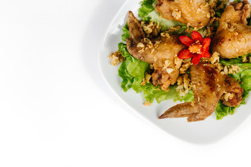 Traditional oriental cuisine of  Vietnam. Breaded Chicken Wings with green salad 