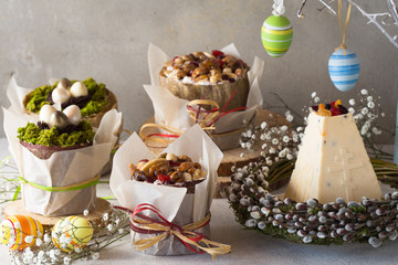 Caramel cottage cheese dessert (Paskha), Easter cakes with icing sugar and colorful painted eggs on table. Traditional Easter treats of Russia and Ukraine for Orthodox Easter. Easter symbols