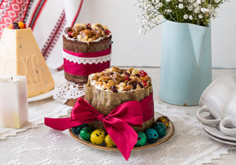 Caramel cottage cheese dessert (Paskha), Easter cakes with icing sugar and colorful painted eggs on table. Traditional Easter treats of Russia and Ukraine for Orthodox Easter. Easter symbols