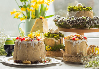 Caramel cottage cheese dessert (Paskha), Easter cakes with icing sugar and colorful painted eggs on table. Traditional Easter treats of Russia and Ukraine for Orthodox Easter. Easter symbols