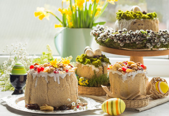 Caramel cottage cheese dessert (Paskha), Easter cakes with icing sugar and colorful painted eggs on table. Traditional Easter treats of Russia and Ukraine for Orthodox Easter. Easter symbols