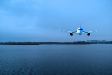 The plane over the river in the evening in nature.