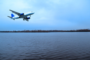 Fototapeta na wymiar The plane over the river in the evening in nature.