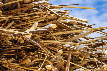 Folded wooden brown and gray planks in a sawmill. Piled alder boards as texture