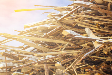 Folded wooden brown and gray planks in a sawmill. Piled alder boards as texture