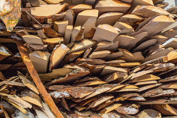 Folded wooden brown and gray planks in a sawmill. Piled alder boards as texture