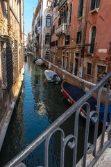 Venice, Veneto, Italy - A view from a bridge in a narrow side canal in Venice on Canale Crande, on a beautiful day in October