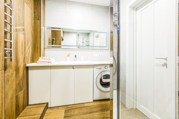 Large furnished bathroom in luxury home with tile floor, fancy cabinets, large mirror, shower, and bathtub