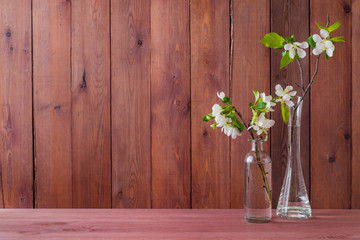 Fototapeta na wymiar Home interior with decor elements. White spring flowers in a vase on a wooden table