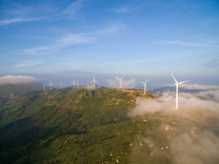 Wind power generator before sunrise sunset ，Wind power generation in the sea of clouds