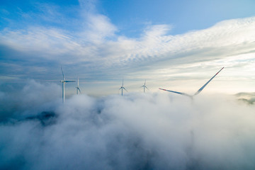 Wind power generator before sunrise sunset ，Wind power generation in the sea of clouds