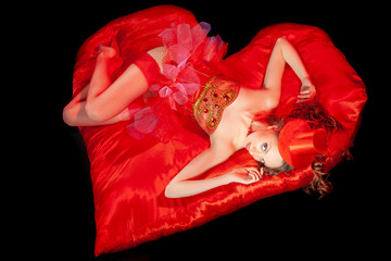 Sexy burlesque dancer stripper in red corset and red hat with brautiful lrgs, on the red heart