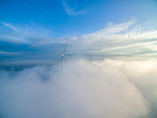 Fototapeta na wymiar Wind power generator before sunrise sunset ，Wind power generation in the sea of clouds