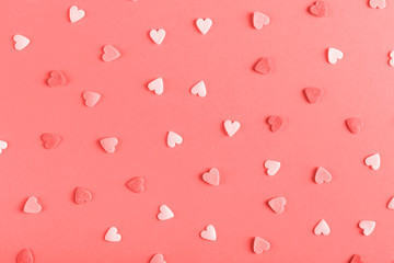 The heart shaped powder like candy is scattered on the table. Happy Easter concept greeting card design.