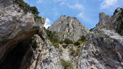Cliff scenery and rock formations on the island of Capri in the Bay of Naples, Italy. Photographed whilst on a boat trip around the island.