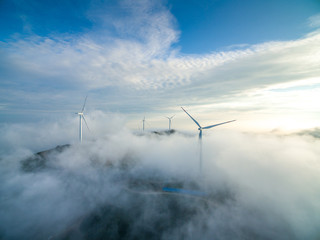 Wind power generator before sunrise sunset ，Wind power generation in the sea of clouds