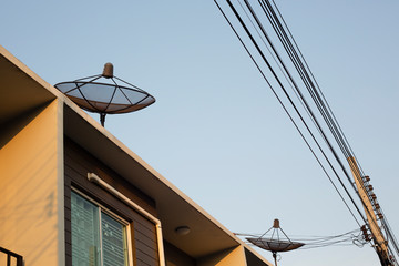 Satellite dish on the roof of the house.