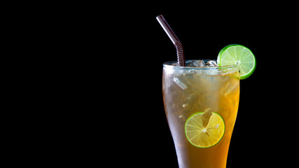 Lemon tea and lemon slice on ice on black background,