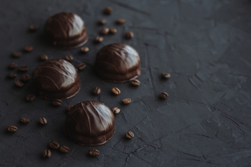 Chocolate cakes and coffee beans on a black background