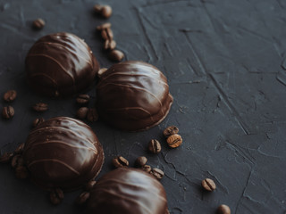 Chocolate cakes and coffee beans on a black background