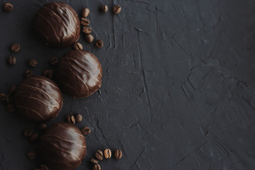 Chocolate cakes and coffee beans on a black background