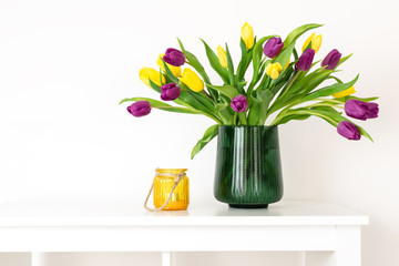 Minimal composition, scandinavian nordic hygge style, home interior, mother day - tulips in green vase, yellow candleholder